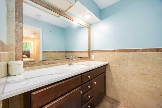 478 Brandon Rd, Conroe, TX 77302 - bathroom featuring tile walls, vanity, and wainscoting