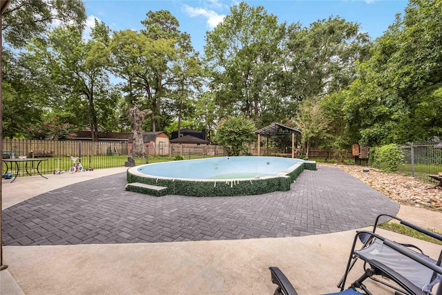 478 Brandon Rd, Conroe, TX 77302 - view of pool with a gazebo, a patio area, a fenced backyard, and view of wooded area