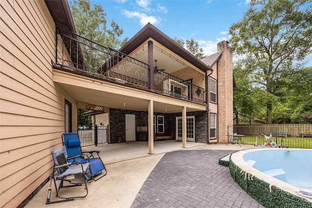 478 Brandon Rd, Conroe, TX 77302 - rear view of house featuring a balcony, a patio area, and a chimney