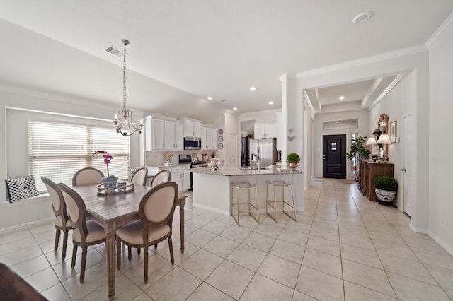 14510 Kasey Flowers Ct, Humble, TX 77396 - dining space featuring light tile patterned flooring, a chandelier, ornamental molding, recessed lighting, and lofted ceiling