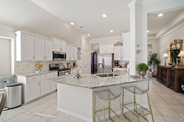 14510 Kasey Flowers Ct, Humble, TX 77396 - kitchen with appliances with stainless steel finishes, light tile patterned flooring, tasteful backsplash, white cabinetry, and ornamental molding