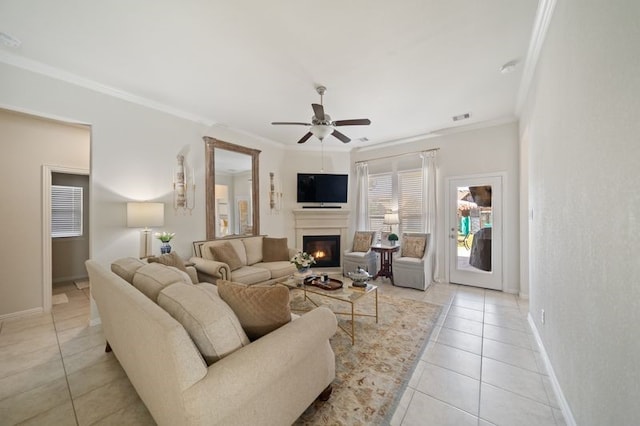 14510 Kasey Flowers Ct, Humble, TX 77396 - living room featuring ornamental molding, light tile patterned floors, ceiling fan, and a warm lit fireplace