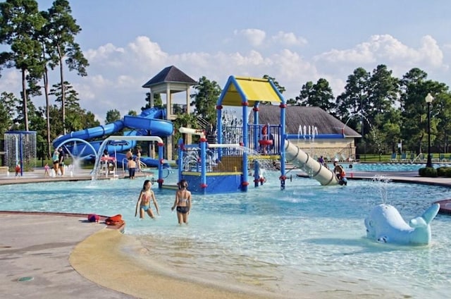 14510 Kasey Flowers Ct, Humble, TX 77396 - community jungle gym featuring a water play area