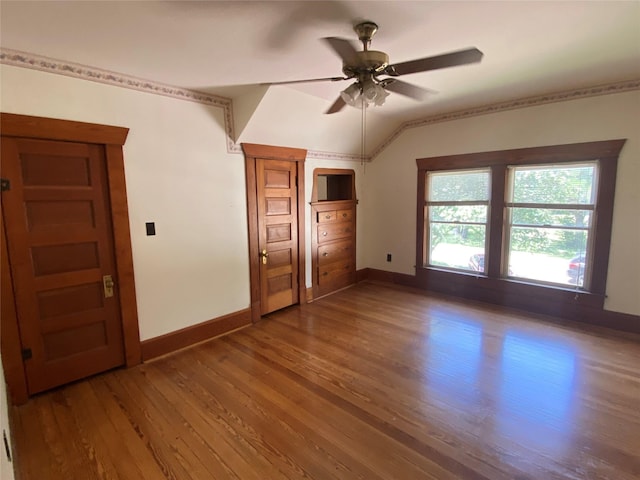 222 N 1st, Wallis, TX 77485 - unfurnished bedroom with wood finished floors, vaulted ceiling, and a ceiling fan