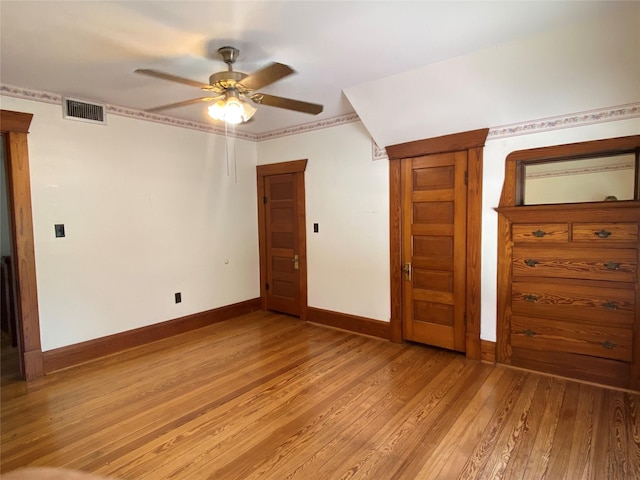 222 N 1st, Wallis, TX 77485 - empty room with light wood-style floors and a ceiling fan