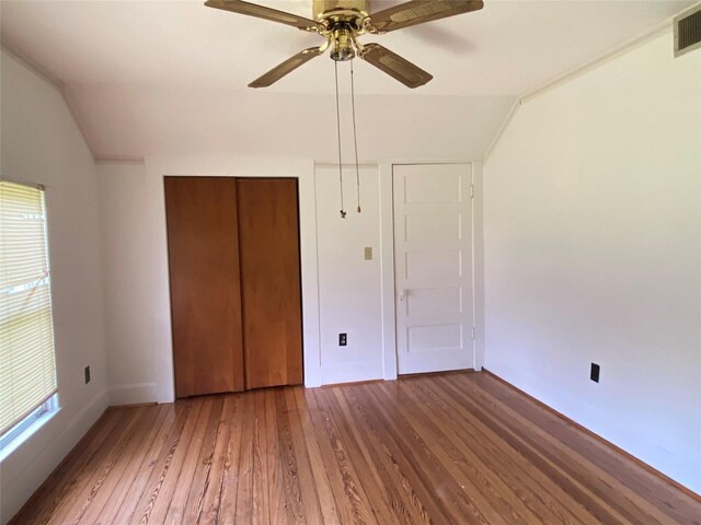222 N 1st, Wallis, TX 77485 - unfurnished bedroom featuring vaulted ceiling, wood-type flooring, a closet, and a ceiling fan