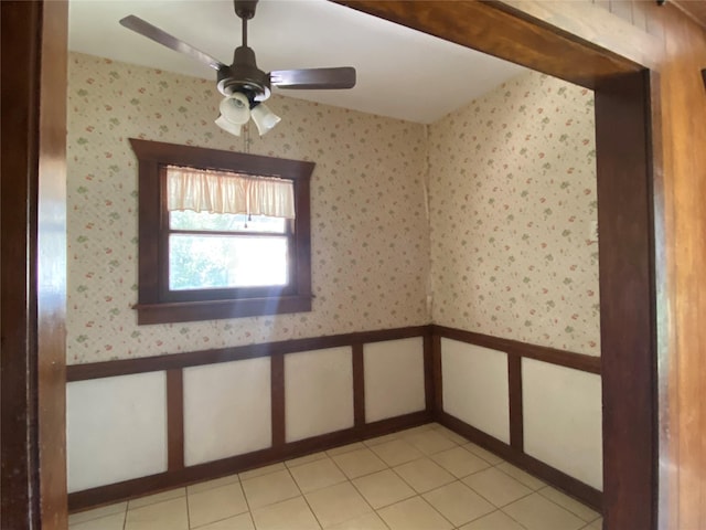 222 N 1st, Wallis, TX 77485 - spare room with ceiling fan, wainscoting, wallpapered walls, and light tile patterned flooring