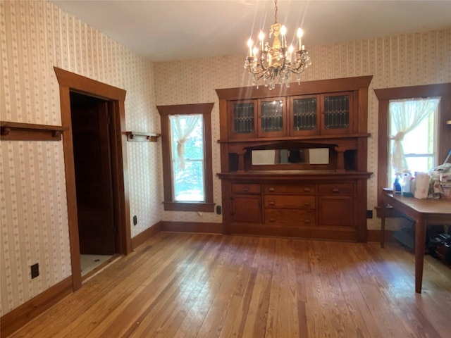 222 N 1st, Wallis, TX 77485 - dining room featuring wallpapered walls, hardwood / wood-style flooring, and a chandelier