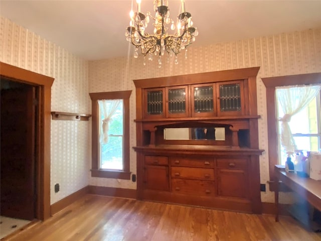 222 N 1st, Wallis, TX 77485 - dining room with wallpapered walls, light wood-style flooring, and a chandelier