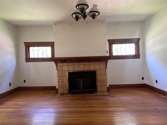 222 N 1st, Wallis, TX 77485 - unfurnished living room with wood finished floors, plenty of natural light, and a chandelier