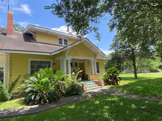 222 N 1st, Wallis, TX 77485 - bungalow-style home featuring a front lawn, a chimney, and a shingled roof