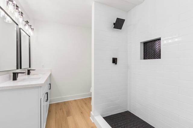 2307 Scott St, La Marque, TX 77568 - full bathroom featuring wood finished floors, vanity, and tiled shower