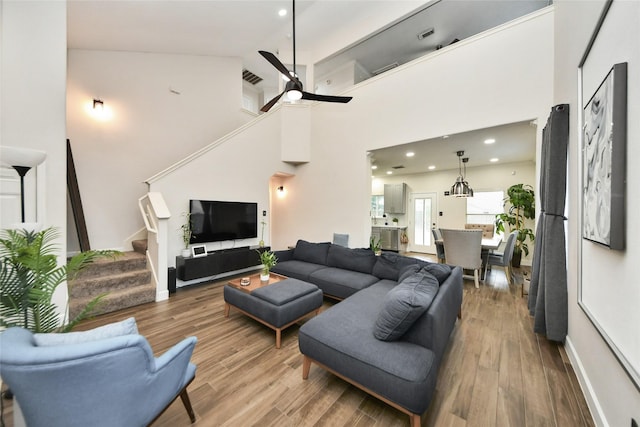 2014 Fisher Trace Ct, Spring, TX 77373 - living area featuring stairs, wood finished floors, a ceiling fan, recessed lighting, and a towering ceiling