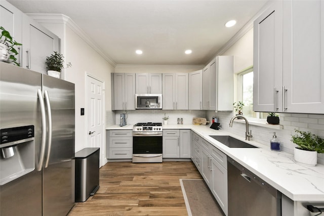 2014 Fisher Trace Ct, Spring, TX 77373 - kitchen featuring stainless steel appliances, ornamental molding, wood finished floors, decorative backsplash, and gray cabinetry
