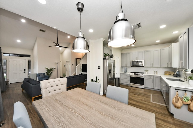 2014 Fisher Trace Ct, Spring, TX 77373 - kitchen with stainless steel appliances, light countertops, dark wood-style floors, open floor plan, and gray cabinetry
