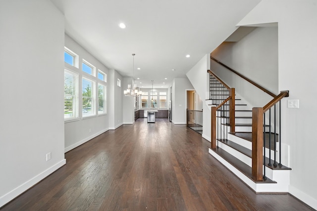 151 E 2nd St, Houston, TX 77007 - unfurnished living room with a chandelier, dark wood-style floors, stairs, and recessed lighting