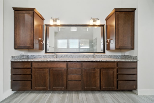 151 E 2nd St, Houston, TX 77007 - bathroom featuring double vanity and wood finished floors