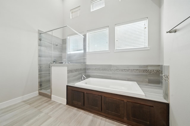 151 E 2nd St, Houston, TX 77007 - full bath with a bath, a stall shower, and wood finished floors