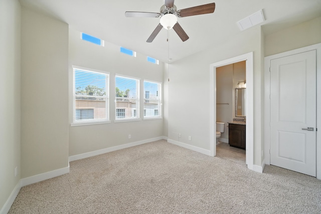151 E 2nd St, Houston, TX 77007 - unfurnished bedroom featuring light colored carpet, ensuite bath, and ceiling fan