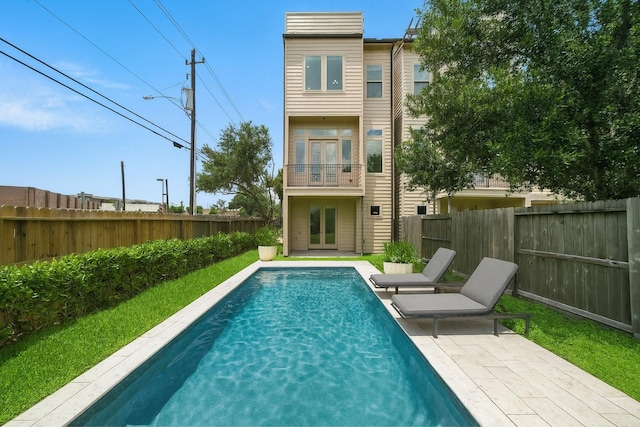 151 E 2nd St, Houston, TX 77007 - rear view of house with french doors, a balcony, and a fenced backyard