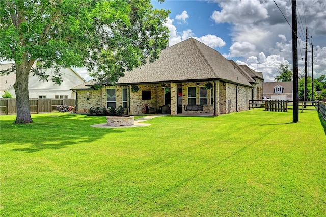 3403 Westhaven Ct, Fulshear, TX 77441 - back of property featuring a fenced backyard, brick siding, an outdoor fire pit, a patio, and roof with shingles