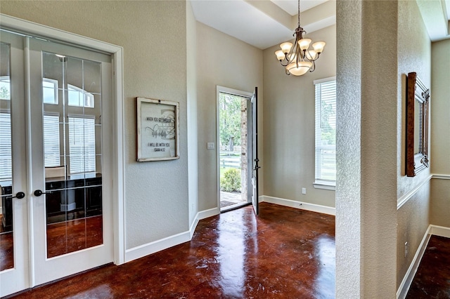 3403 Westhaven Ct, Fulshear, TX 77441 - foyer entrance with finished concrete flooring, a chandelier, and a textured wall