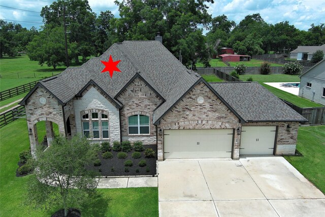 3403 Westhaven Ct, Fulshear, TX 77441 - french country style house featuring roof with shingles, an attached garage, stone siding, driveway, and a chimney