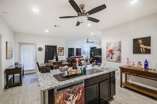826 Green Clover Ln, Rosharon, TX 77583 - kitchen with dishwasher, light wood-style flooring, ceiling fan, open floor plan, and light stone counters