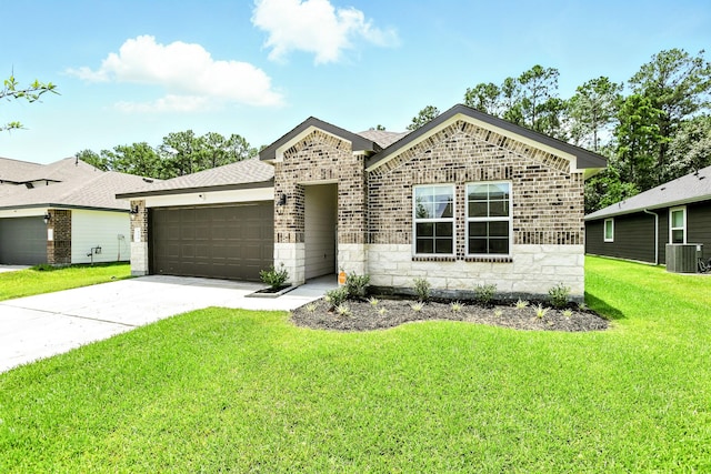 621 Little Spring Ct, Anahuac, TX 77514 - view of front of property with brick siding, an attached garage, concrete driveway, and stone siding