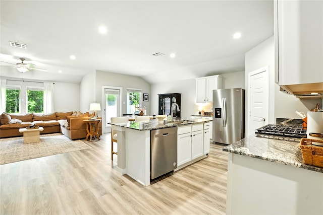 621 Little Spring Ct, Anahuac, TX 77514 - kitchen with appliances with stainless steel finishes, a ceiling fan, healthy amount of natural light, white cabinets, and recessed lighting