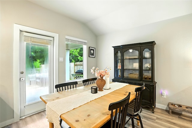 621 Little Spring Ct, Anahuac, TX 77514 - dining room with light wood-style flooring and lofted ceiling