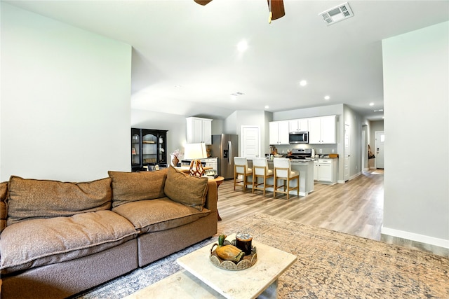 621 Little Spring Ct, Anahuac, TX 77514 - living room with light wood-style floors, ceiling fan, and recessed lighting