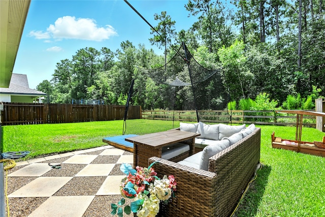 621 Little Spring Ct, Anahuac, TX 77514 - fenced backyard with an outdoor hangout area, a patio, and view of wooded area