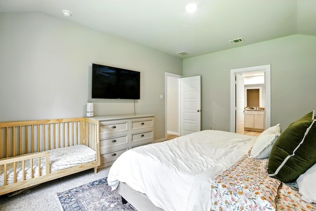 621 Little Spring Ct, Anahuac, TX 77514 - bedroom featuring vaulted ceiling, ensuite bath, and light colored carpet