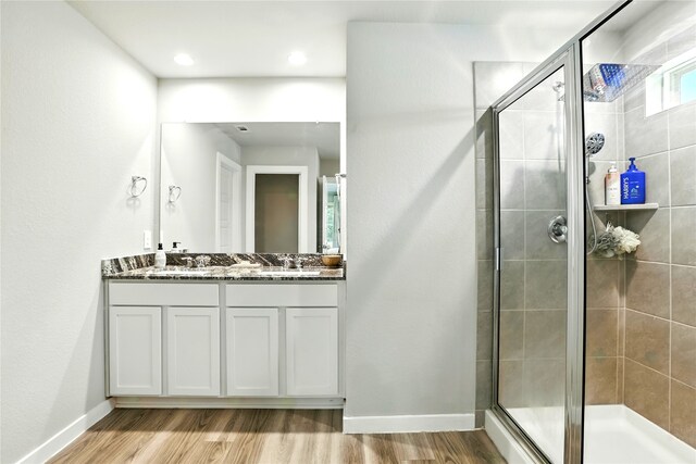 621 Little Spring Ct, Anahuac, TX 77514 - bathroom with double vanity, a shower stall, and wood finished floors