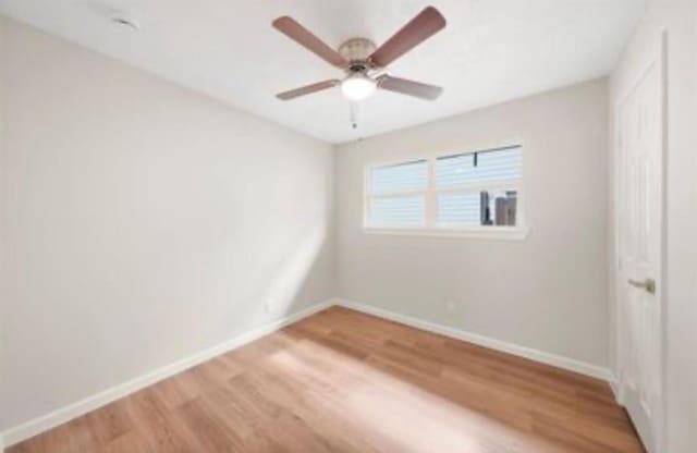 202 Sylvia St, Deer Park, TX 77536 - unfurnished bedroom featuring light wood-style flooring and ceiling fan
