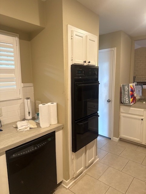 7955 Fawn Terrace Dr, Houston, TX 77071 - kitchen with black appliances, white cabinets, light tile patterned flooring, and light countertops