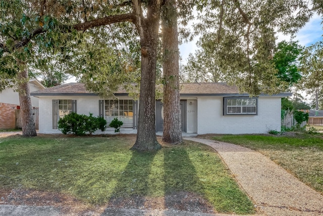 23131 Earlmist Dr, Spring, TX 77373 - ranch-style home with brick siding and a front lawn