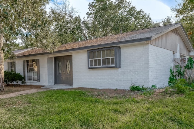 23131 Earlmist Dr, Spring, TX 77373 - ranch-style home with brick siding, a shingled roof, and a front lawn