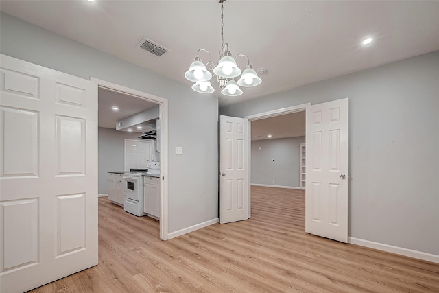23131 Earlmist Dr, Spring, TX 77373 - unfurnished dining area featuring light wood finished floors, a chandelier, and recessed lighting