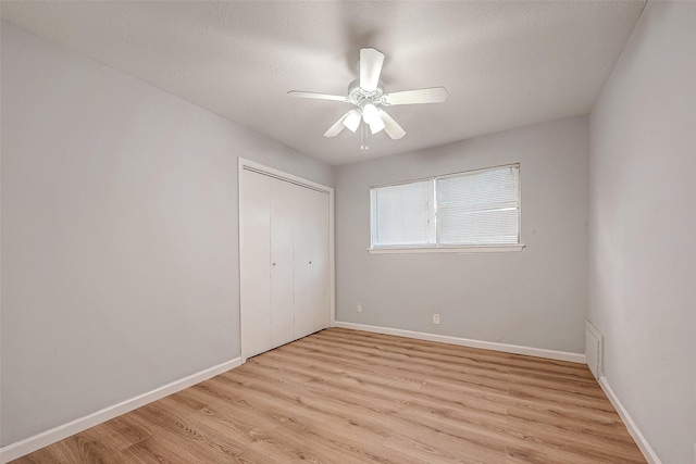 23131 Earlmist Dr, Spring, TX 77373 - unfurnished bedroom with light wood-type flooring, a closet, and a ceiling fan
