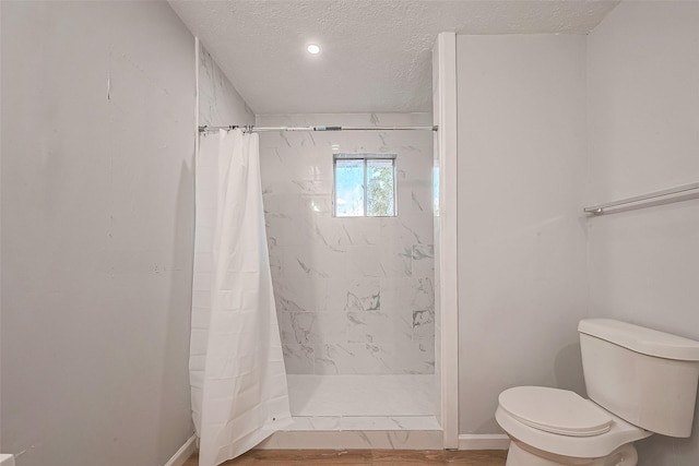 23131 Earlmist Dr, Spring, TX 77373 - bathroom with a textured ceiling, a shower stall, and wood finished floors