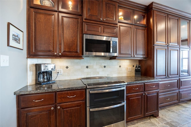 1906 Nogalus Dr, Houston, TX 77532 - kitchen with stainless steel appliances, decorative backsplash, dark stone countertops, and glass insert cabinets