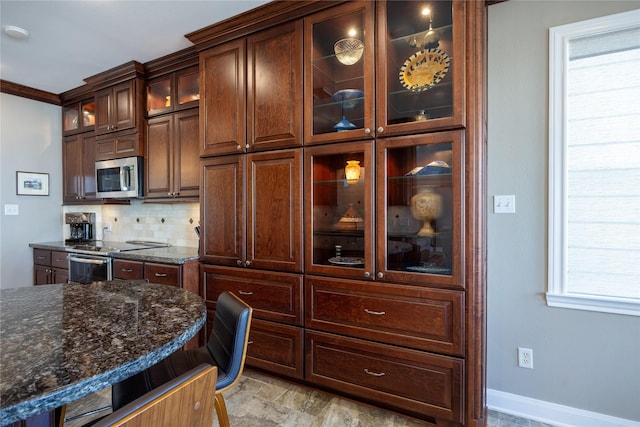 1906 Nogalus Dr, Houston, TX 77532 - kitchen with decorative backsplash, stainless steel appliances, glass insert cabinets, dark stone counters, and dark brown cabinets