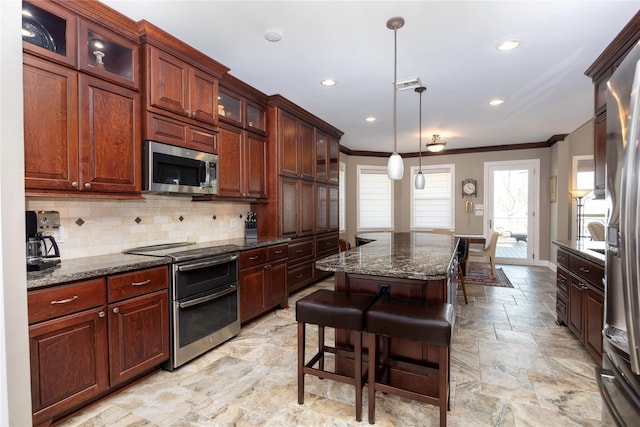 1906 Nogalus Dr, Houston, TX 77532 - kitchen featuring stainless steel appliances, crown molding, tasteful backsplash, recessed lighting, and a kitchen bar