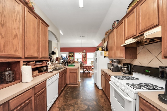 7807 Board Xing, Conroe, TX 77304 - kitchen with white appliances, under cabinet range hood, light countertops, a peninsula, and brown cabinets