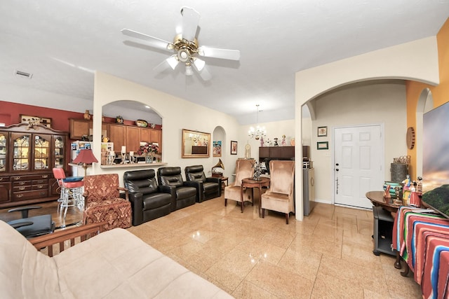 7807 Board Xing, Conroe, TX 77304 - living area with arched walkways, a ceiling fan, a chandelier, and granite tiled floors