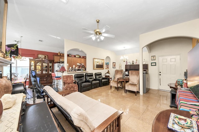 7807 Board Xing, Conroe, TX 77304 - living area with arched walkways, ceiling fan, a chandelier, and dark aggregate flooring