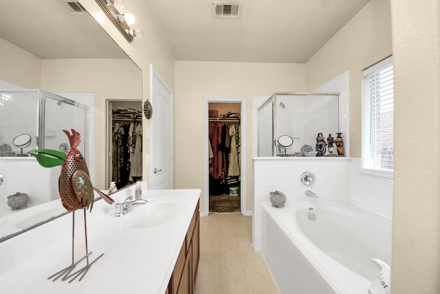 7807 Board Xing, Conroe, TX 77304 - bathroom with vanity, a bath, a shower stall, and a walk in closet