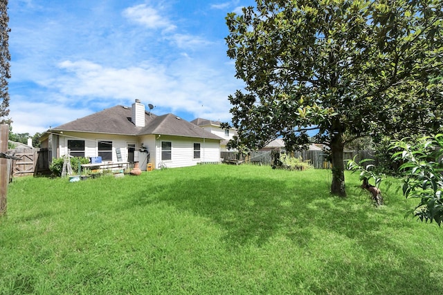 7807 Board Xing, Conroe, TX 77304 - back of property with a chimney and a fenced backyard